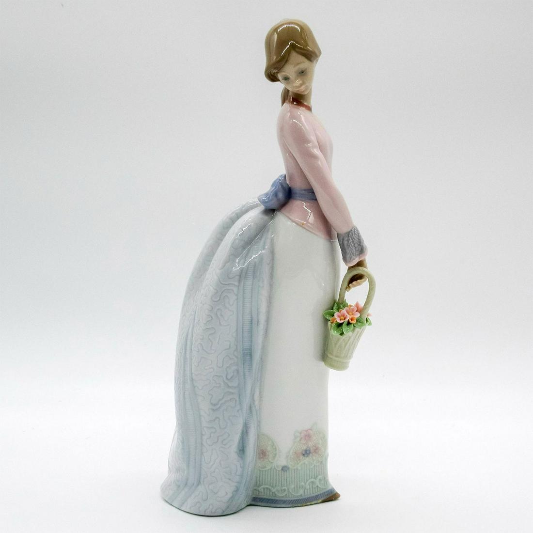 Basket Of Love 1007622 - Lladro Porcelain Figurine: Glossy finish; Collector's Society Lladro backstamp. A young lady holding a basket of flowers. Includes original box: 7.5"L x 5.75"W x 12.75"H. Artist: Jose Puche Issued: 1994-1994 Dimensions: 9.75"H 