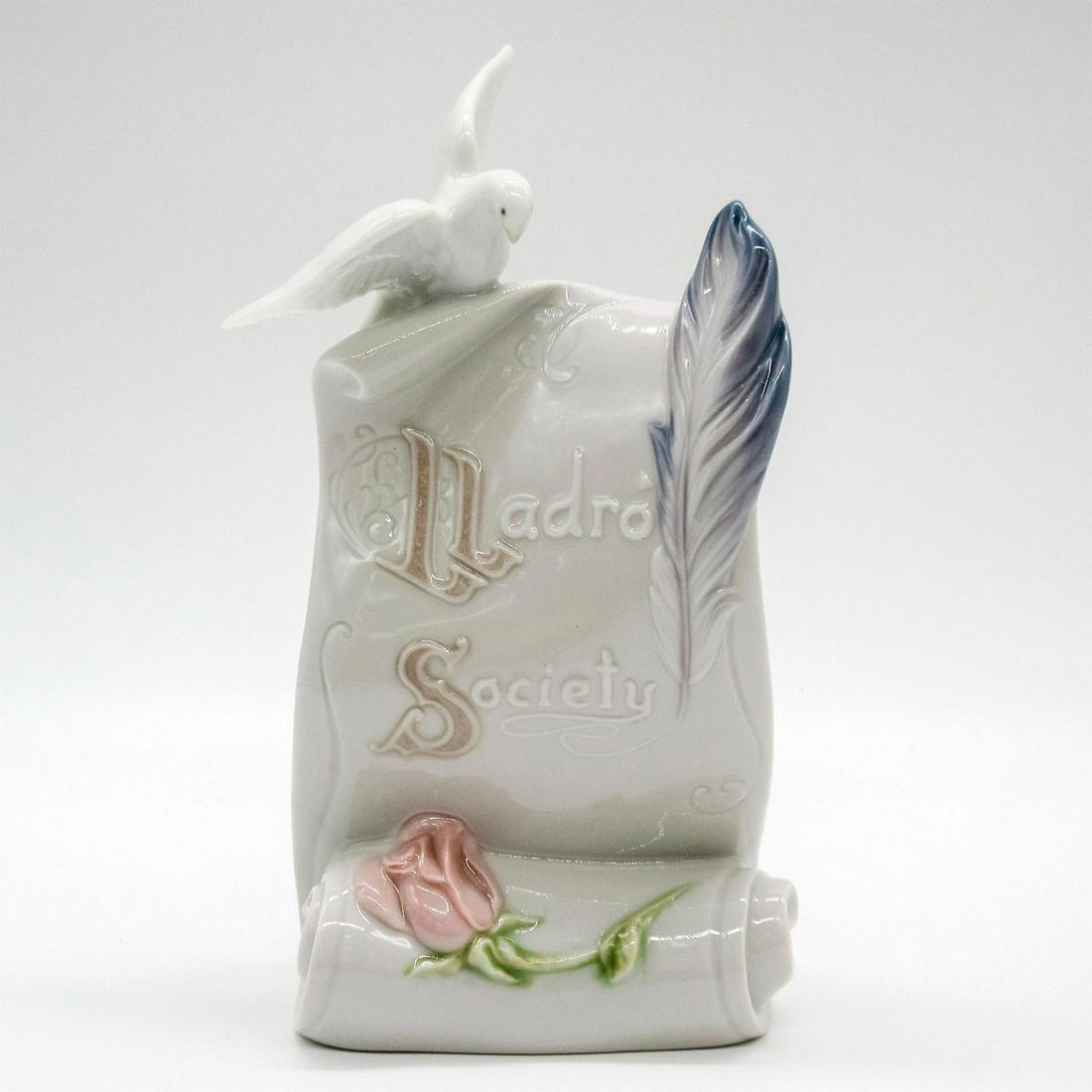 Art Brings Us Together 1007677 - Lladro Porcelain Figurine: Glossy finish; Lladro Society backstamp. A 'Lladro Society' scroll with a dove, rose, and feather. Includes original box: 8"L x 4.75"W x 3.5"H. Artist: Virginia Gonzalez Issued: 1999-1999 Dimensions: 