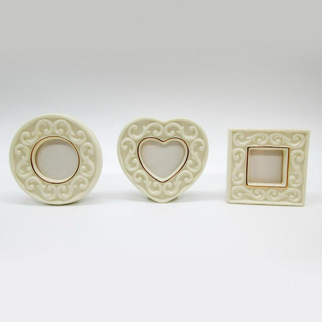3 Set of Small Lenox Fine China Picture Frames: White fine sculpted frames with reliefs of laurel scrolls with 24 kart gold. Includes certificate of authenticity and original box: 10"L x 3.5"W x 1.75"H. Circle frame: 2.75"W, sight size: 1.25"W. Hea