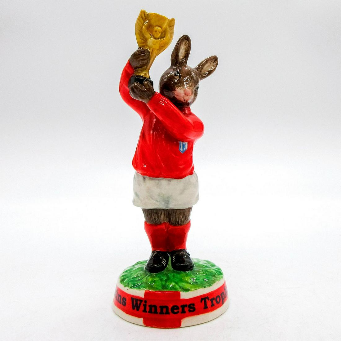 Cup Winner's Trophy 1966 DB410 - Royal Doulton Bunnykins: Glazed porcelain bunny holding trophy. Royal Doulton backstamp stamped on bottom. Artist: Doulton Studios Issued: 2006 Dimensions: 5"H Edition Number: 771 Edition Size: 1000 Manufacturer: Royal Doulto