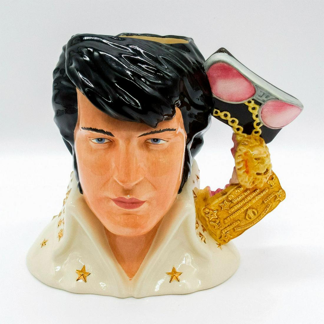 Elvis Presley EP6 (Vegas) - Large - Royal Doulton Character Jug: Sunglasses, medallion, championship belt, badge, and lei handle. Includes certificate of authenticity. During his public appearances in the 1970's, Elvis became famous for wearing his "Easy Ri