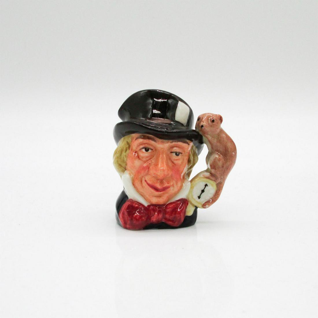 Mad Hatter D6606 - Mini - Royal Doulton Character Jug: Variation One, black hat; dark red bow tie. A character from Lewis Carroll's "Alice's Adventures in Wonderland," the Mad Hatter wears a watch that tells time in months, rather than in