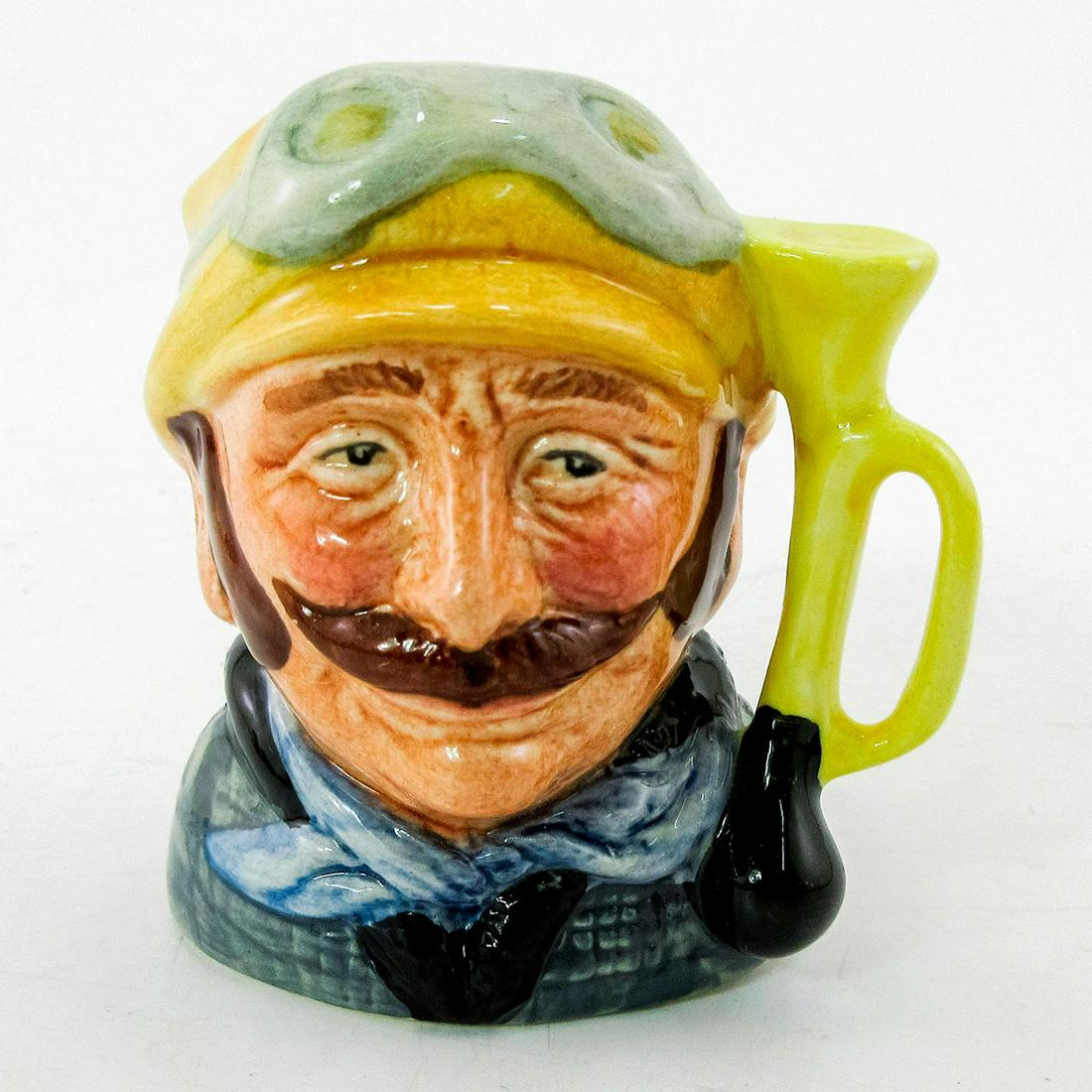 Veteran Motorist D6641 - Mini - Royal Doulton Character Jug: Yellow hat; green coat; blue scarf. Royal Doulton backstamp. Artist: David B. Biggs Issued: 1973 - 1983 Dimensions: 2.5"H Manufacturer: Royal Doulton Country of Origin: England