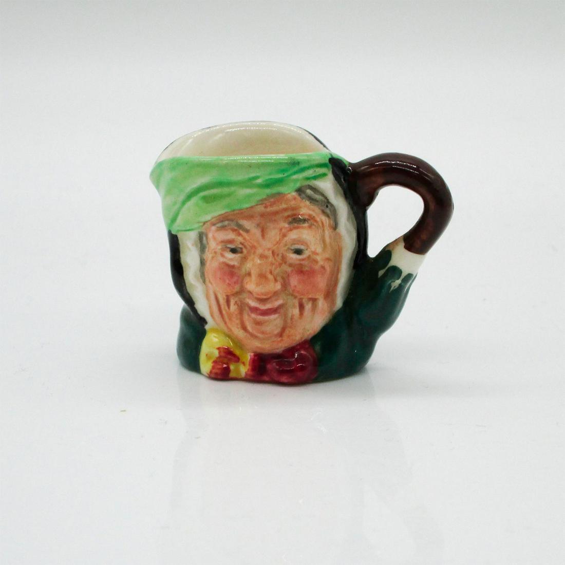 Sairey Gamp D6146 - Tiny - Royal Doulton Character Jug: Black hair; light green band; dark green coat; yellow and burgundy bow; green umbrella with brown handle. In Charles Dickens' 1843 novel, "Martin Chuzzlewit" Sairey Gamp is a gossiping, gi