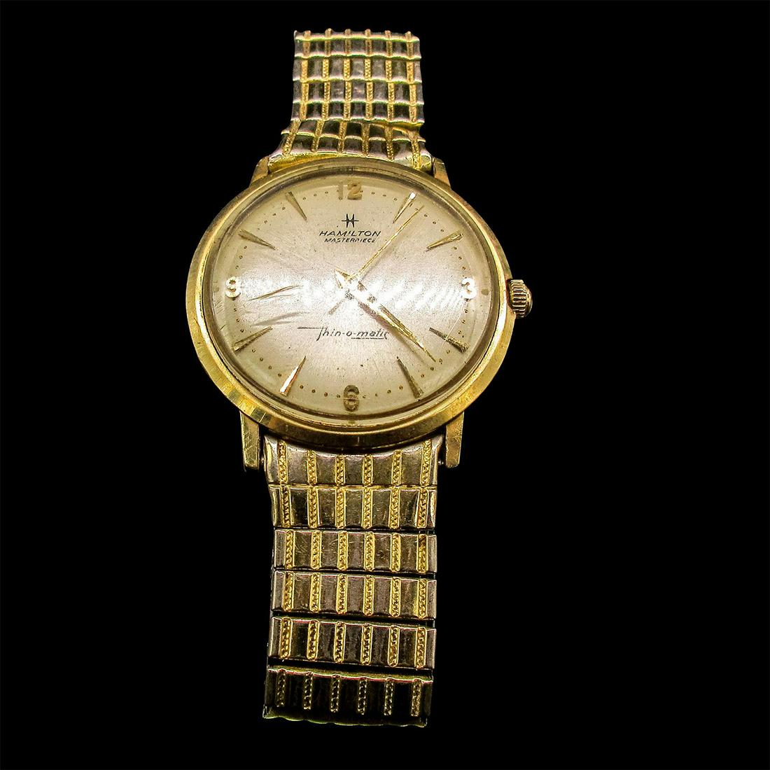 Hamilton Thin-o-matic Watch: Vintage gold-filled watch with pearlescent dial. Wristband has gold-filled caps with stainless steel bottoms. Inscription on the back reads "Presented to Harold R. Satterfield for more than a quarter