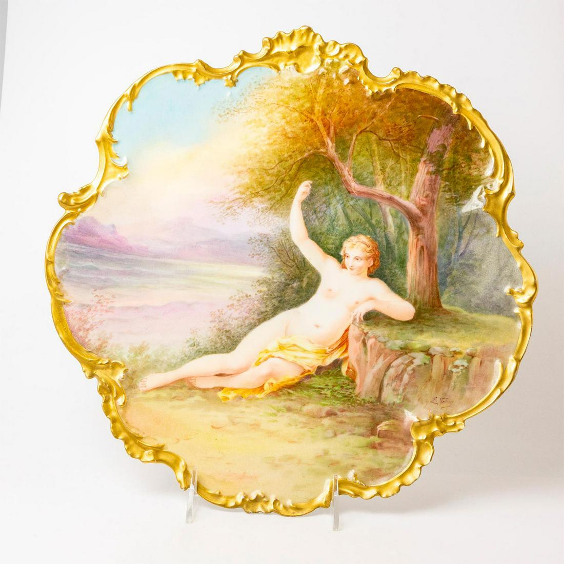 Antique Limoges French Porcelain Charger: Large hand painted wall plate depicting a nude beauty laying down by a tree. Artist signed lower right. Limoges, France backstamp. This lot has no reserve. Dimensions: 1.5" H x 13.5" Diameter Country 