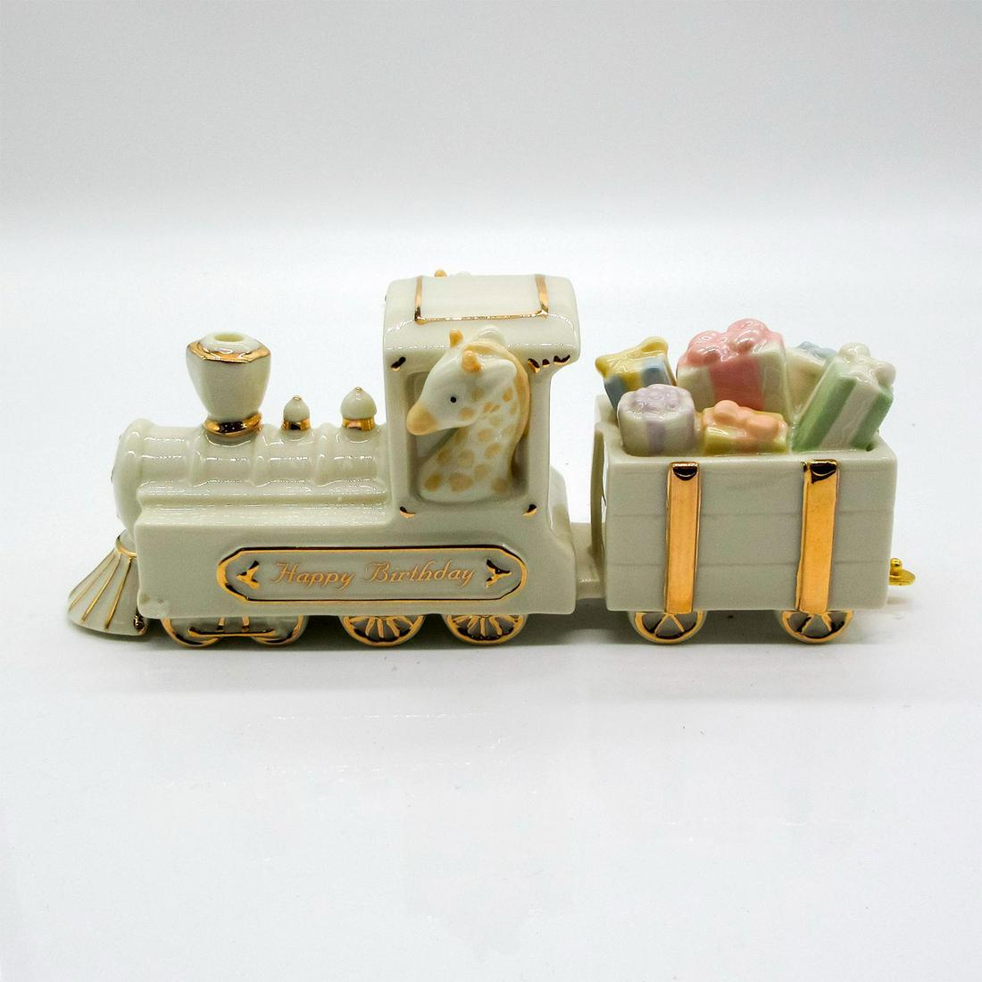 Lenox Train Figurine, The Happy Birthday Express: Original hand painted glossy ivory colored golden accented piece. Features giraffe as engineer, attached to train car of gifts. Includes original Lenox box. Dimensions of box: 9.5 x 5 x 9.5. Lenox bac