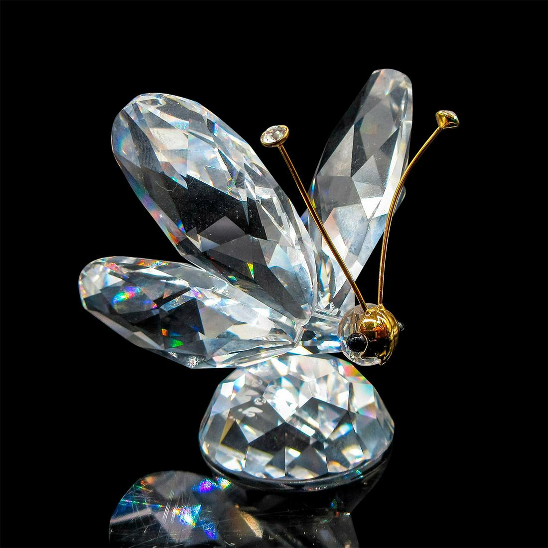 Swarovski Crystal Figurine, Butterfly: Lead crystal, depicting a butterfly with gold mask on nose. Swarovski etched backstamp. Comes in original box which is 3.25"D x 4.75"H. Issued: 20th c. Dimensions: 1.75" L x 2" H Manufacturer: