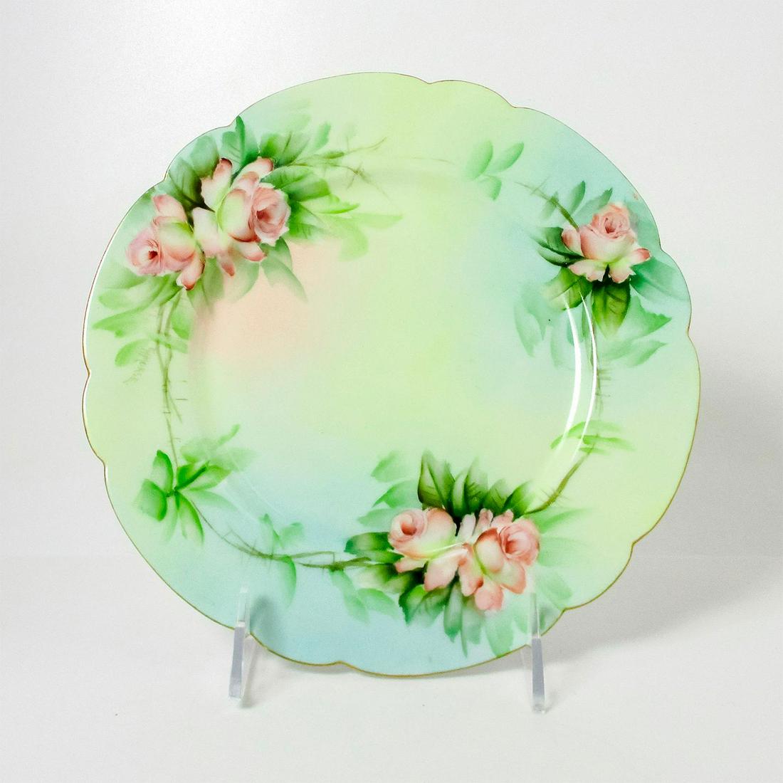 Antique Elite Limoges France Porcelain Collectors Plate: Scalloped gilded rim. Hand painted flowers in the center. Elite Limoges backstamp. Dimensions: 1" H x 8.5" Diameter Manufacturer: Limoges Country of Origin: France This item has no reserve.