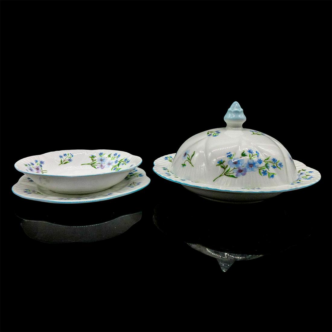 Set of 3 Shelley England Serveware, Blue Rock: One covered dish, one open dish and one plate. Vintage bone china in a gentle blue floral motif. Shelley England backstamp. Covered dish 7"W x 4.25"H. Small nut/candy dish 5.5"W x 1"H.