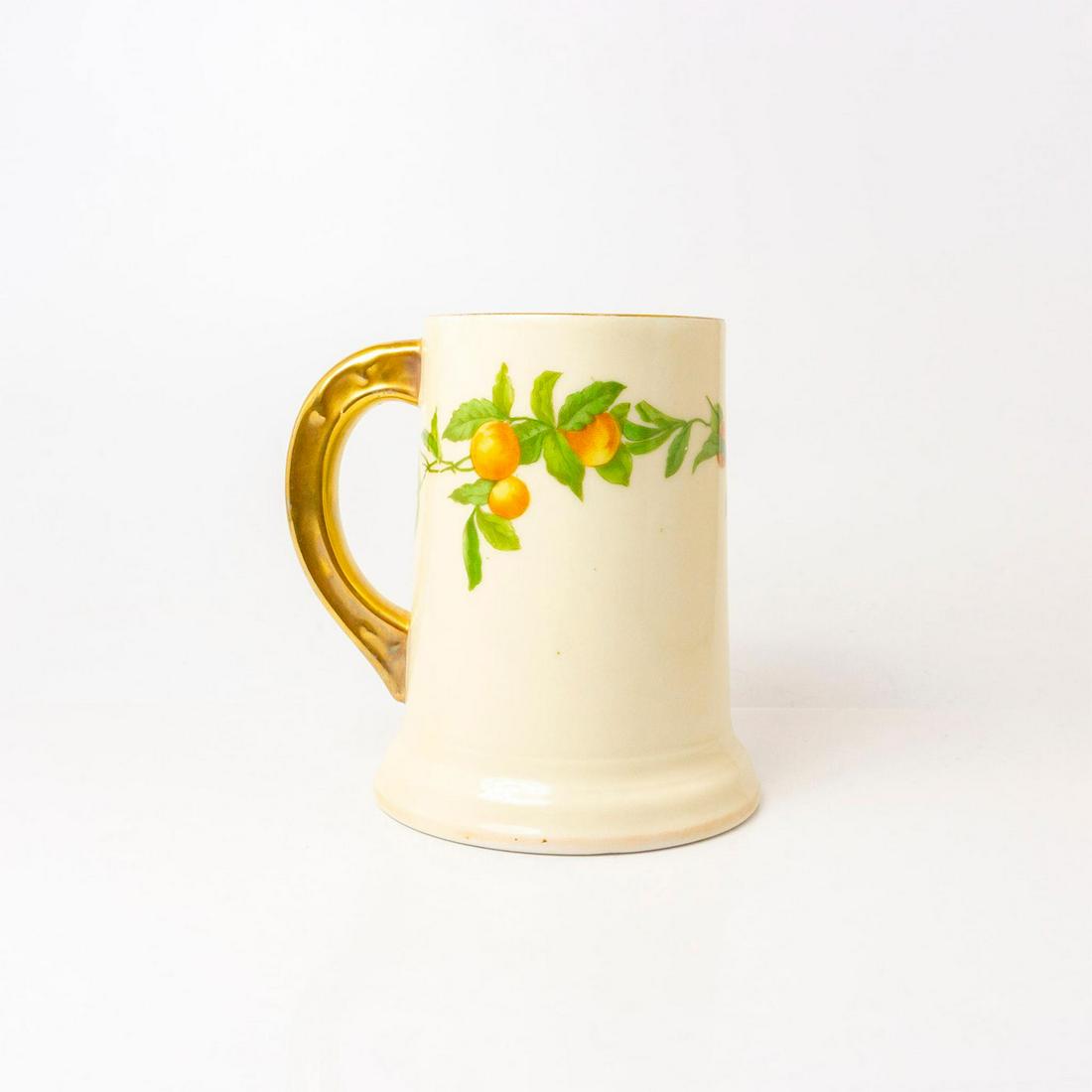 Antique Tressemanes & Vogt Limoges France Porcelain Tankard: Gilded handle and finely painted with peaches and leaves cream color body. V&T Limoges backstamps. Dimensions: 5.25" H x 4.5" Diameter Country of Origin: France This item has no reserve.