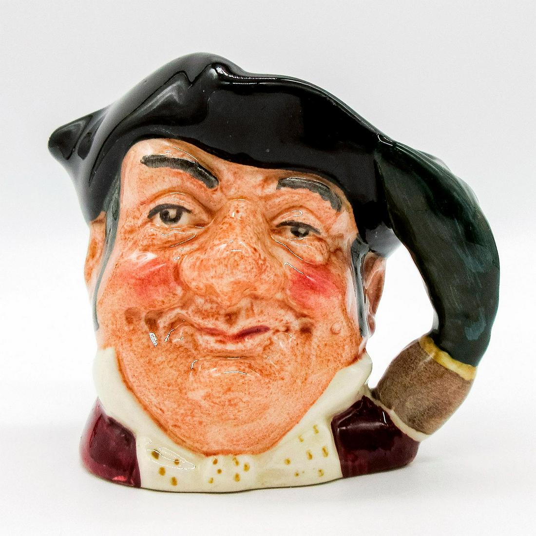 Mine Host D6513 - Mini - Royal Doulton Character Jug: Black tricorn; red coat; white bow tie with gold spots. The forerunner of today's English publican, this cheerful man would hang a pine bough on the door of his home to let travelers know that refresh