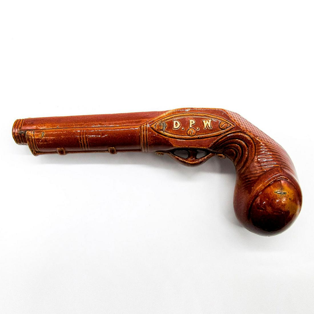 Doulton Lambeth DPW Stoneware Pistol Flask: Advertising stoneware flask in the shape of a pistol. Dewar's Perth Whisky and D.P.W. marked on body. Doulton Lambeth impressed mark. #flask #pistol #Doulton&Watts #UK Issued: c. 1840 Dimensions: 9.5"