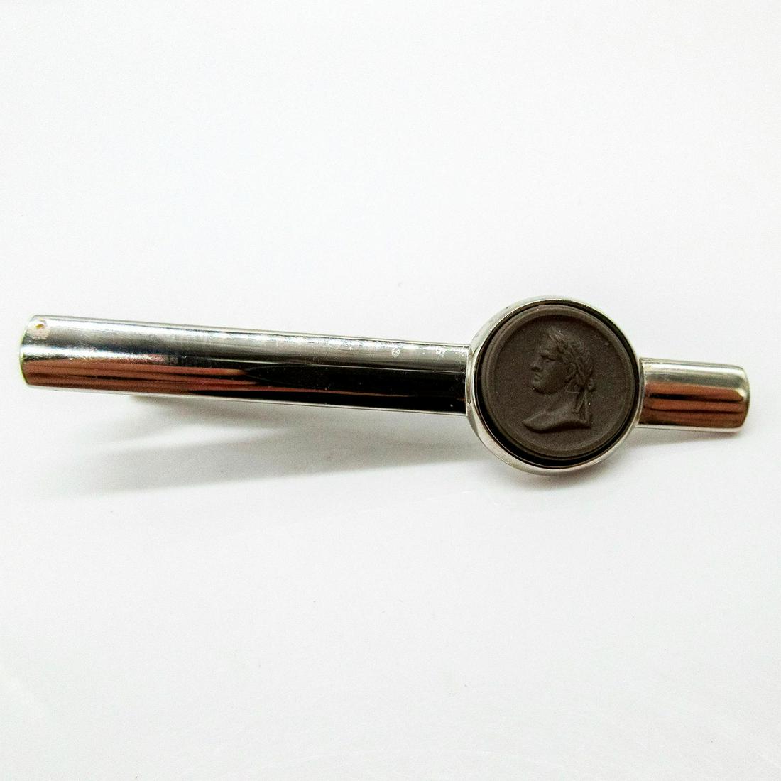 Wedgwood Taupe Jasperware Tie Clip, Caesar: Silver toned tie clip with relief of Julius Caesar on Jasperware. Wedgwood incised backstamp. Includes box. Front face: 5"D. #Wedgwood #Jasperware #Tieclip Issued: 20th c. Dimensions: 2.5"L Manufa