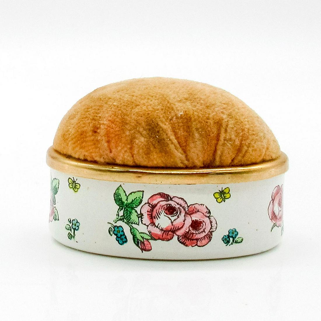 Halcyon Days, Pin Cushion: White oval pin cushion with pink floral details. Halcyon Days backstamp. #HalcyonDays Issued: 20th c. Dimensions: 1.75"W Manufacturer: Halcyon Days Country of Origin: England
