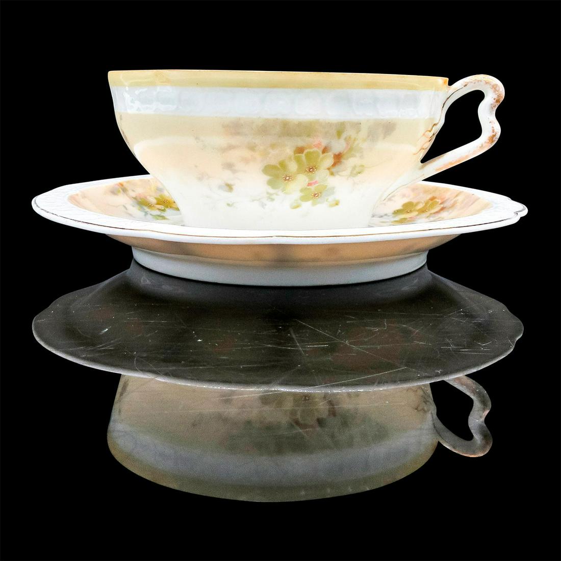 Rosenthal China Mustache Tea Cup and Saucer: Hand-painted porcelain in a light peach with delicate flowers motif and gold tone rim. Moustache partition to protect moustache from beverage. Rosenthal China backstamp. Cup size - 2.25"H x 4.75&#