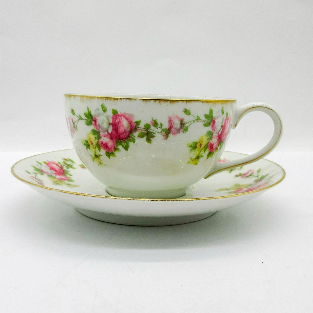 Tressemanes and Vogt Moustache Tea Cup & Saucer: White porcelain with floral and leaf design with gilt rim. T & V backstamp. Cup size - 2.25"H x 3.75" diameter. Saucer size - 6" diameter. Issued: 20th c. Manufacturer: Tressemanes and