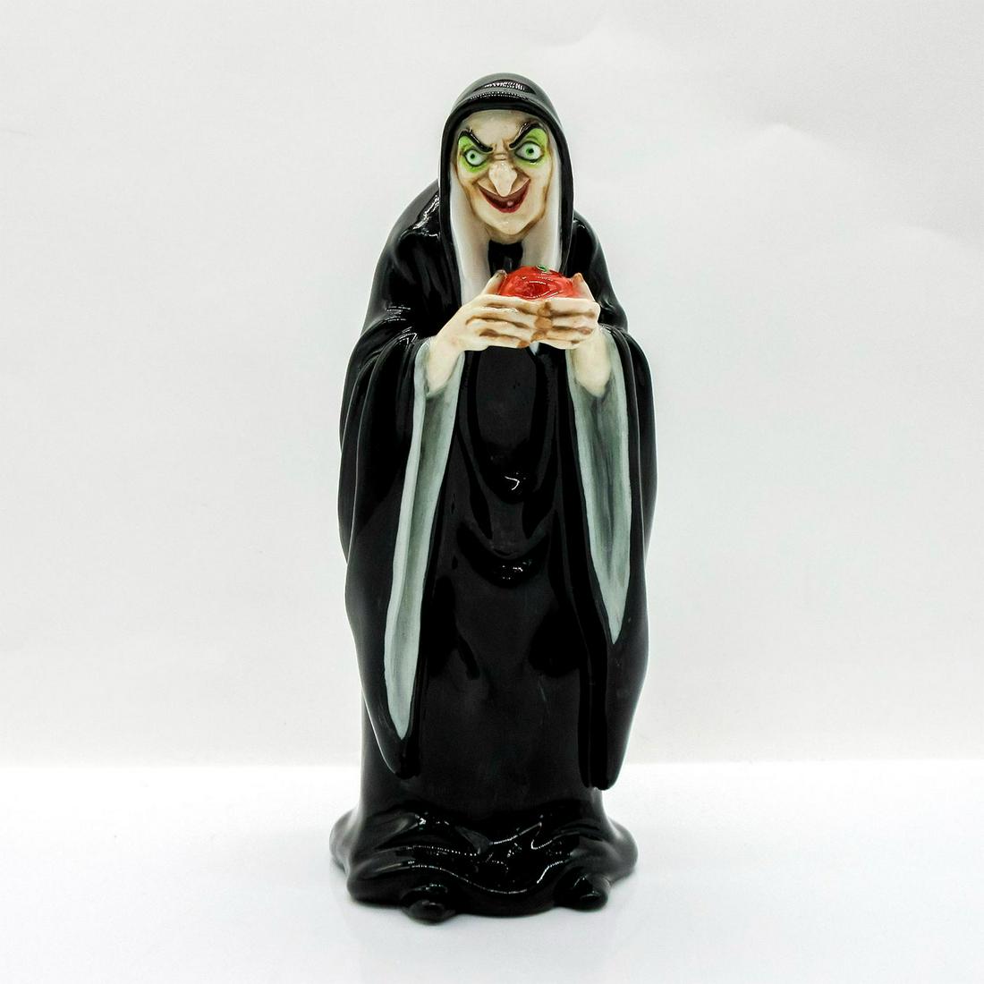 Royal Doulton Disney Figurine, The Witch, Snow White HN3848: Hand painted glazed bone china. The Witch in a black hooded robe, holding an apple, with an evil smiling expression. Royal Doulton backstamp. Includes Certificate of Authenticity. In original box, 10"