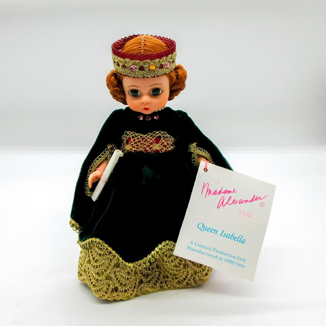 Vintage Madame Alexander Doll, Queen Isabella: Limited Edition, commemorating the 500th anniversary of the discovery of the new world. Dressed in green and gold dress, with crown, and gold shoes. Madame Alexander backstamp on back. Dimensions: 7.5