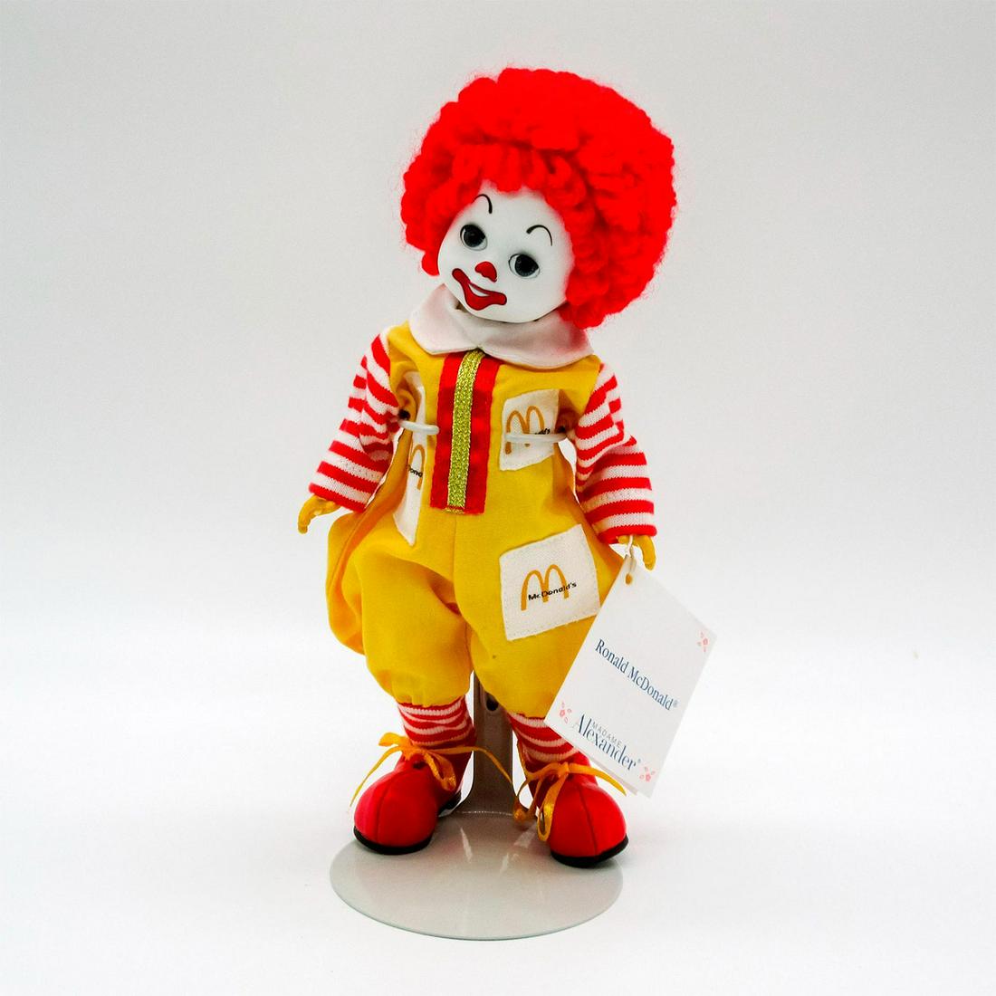 Vintage Madame Alexander Doll, Ronald McDonald: Dressed in yellow, red, and white jumpsuit, and red shoes. Madame Alexander backstamp on back. Comes with stand. This item has no reserve. Dimensions: 8" H Manufacturer: Madame Alexander Country of Or