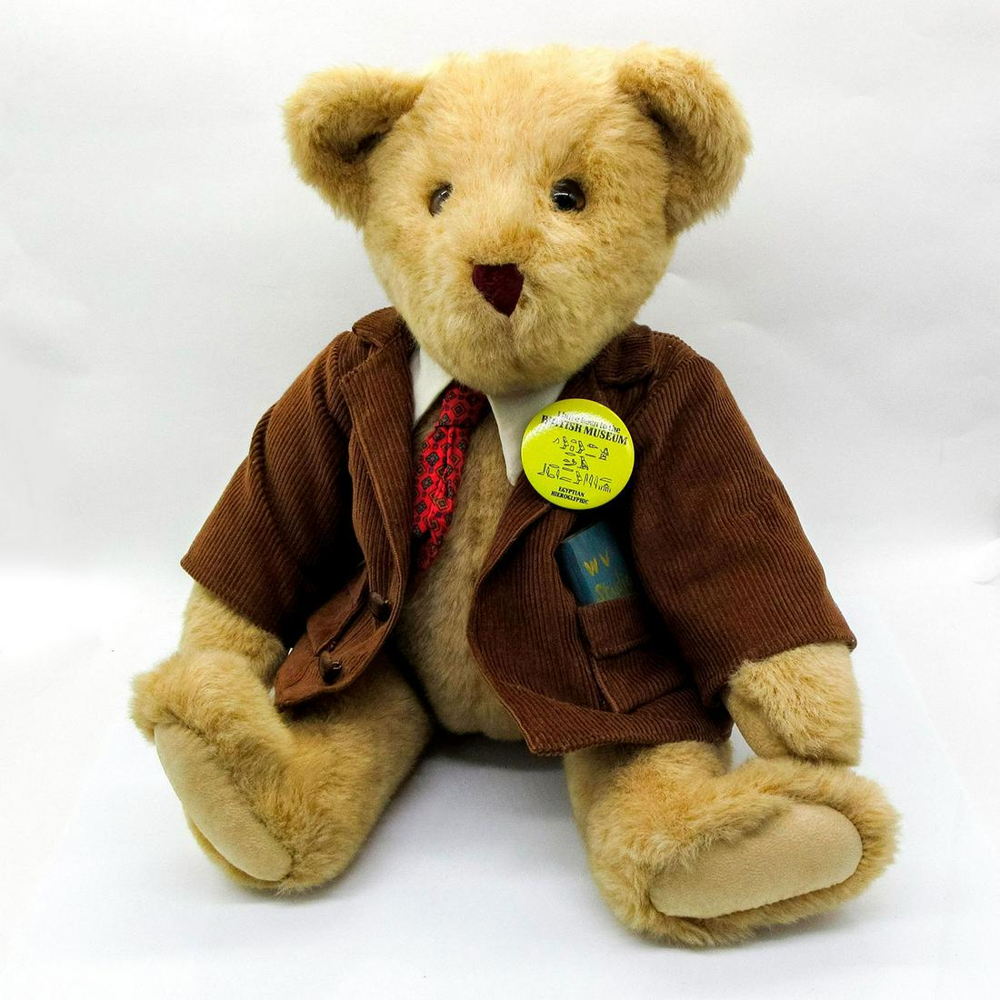 Vermont Teddy Bear Company, Archeology Professor: A distinguished bear in a corduroy jacket with a British Museum Egyptian Hieroglyphic button on his lapel. Arms and legs are moveable. Issued: 20th c. Dimensions: 14" W x 14.5" H Country of Origin: Un