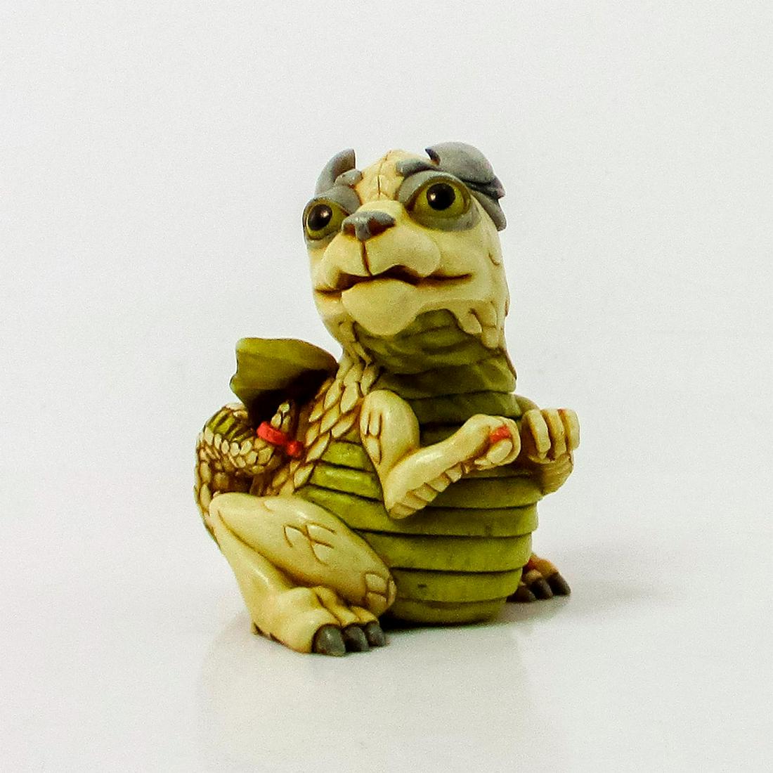 Harmony Kingdom Trinket Box, Jada, Dragon: Resin trinket box figurine of a green and sandstone dragon. The top can be removed to reveal a mirror and chalice. From the Treasure Jests Collection. Includes original box, 3.75"L x 4"W x 3"H. Issued