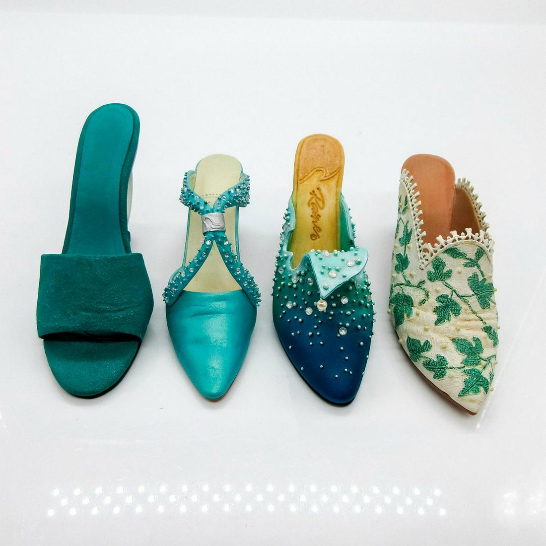 4pc Raine Willitts Designs Just the Right Shoe Figurines: Includes: "Touch of Lace" (nr 25061, 1.5"H), "The Wave" (nr 25060, 1.625"H), "Society Slide" (nr 25064, 1.75"H), and "Geometrika" (nr 25029, 2"H). Raine Willitts Designs backstamp on back. #RaineWilli