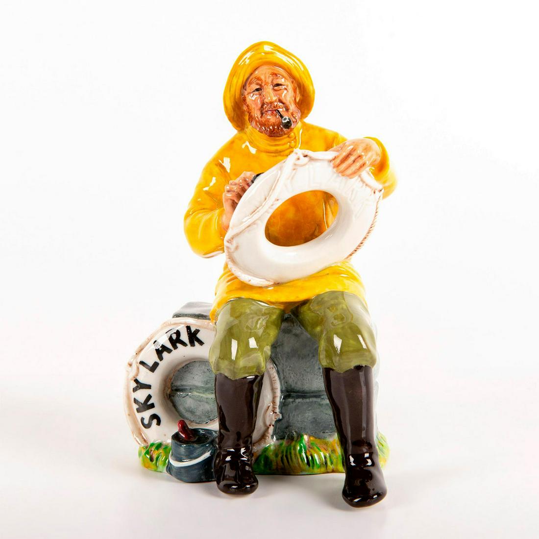 The Boatman (Skylark) HN2417 - Royal Doulton Figurine: Seated in man in bright yellow shirt, olive green pants and black boots. Life preserver marked as 'Skylark'. Series: Sea Characters. Royal Doulton backstamp. Weight: 1 lb 1 oz #royaldoulton #b