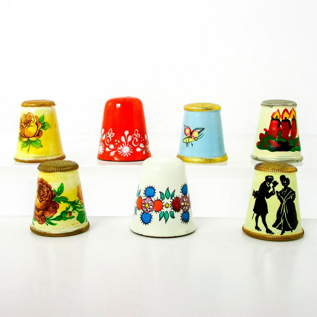7pc Rare Vintage Austrian Thimbles Ceramic and Enamel: Beautiful collectible pieces. In various finely painted designs including a courting couple, flowers, butterfly and candles.