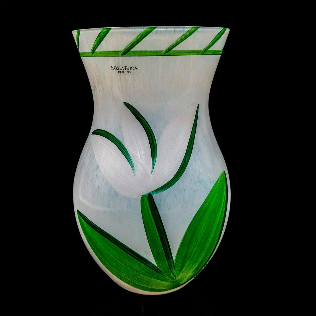Kosta Boda Glass Vase, Tulipa: White translucent glass flower vase; hand-painted white tulip flowers on side. UHV/ZP signed along the base. Kosta Boda Ulrica Vallien etched on base. Comes with original box; size - 8.5"H x 5.5&#