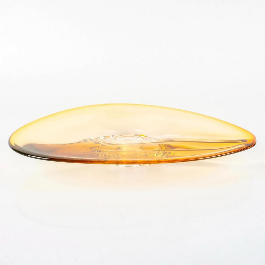Kosta Boda Goran Warff Art Glass Dish, Vision: Large decorative glass dish; soft transparent amber coloration. Unique, asymmetrical human eye inspired design. Kosta Boda, G Warff 7070326 etched on base. Artist: Goran Warff Issued: 2008 Dimensions: