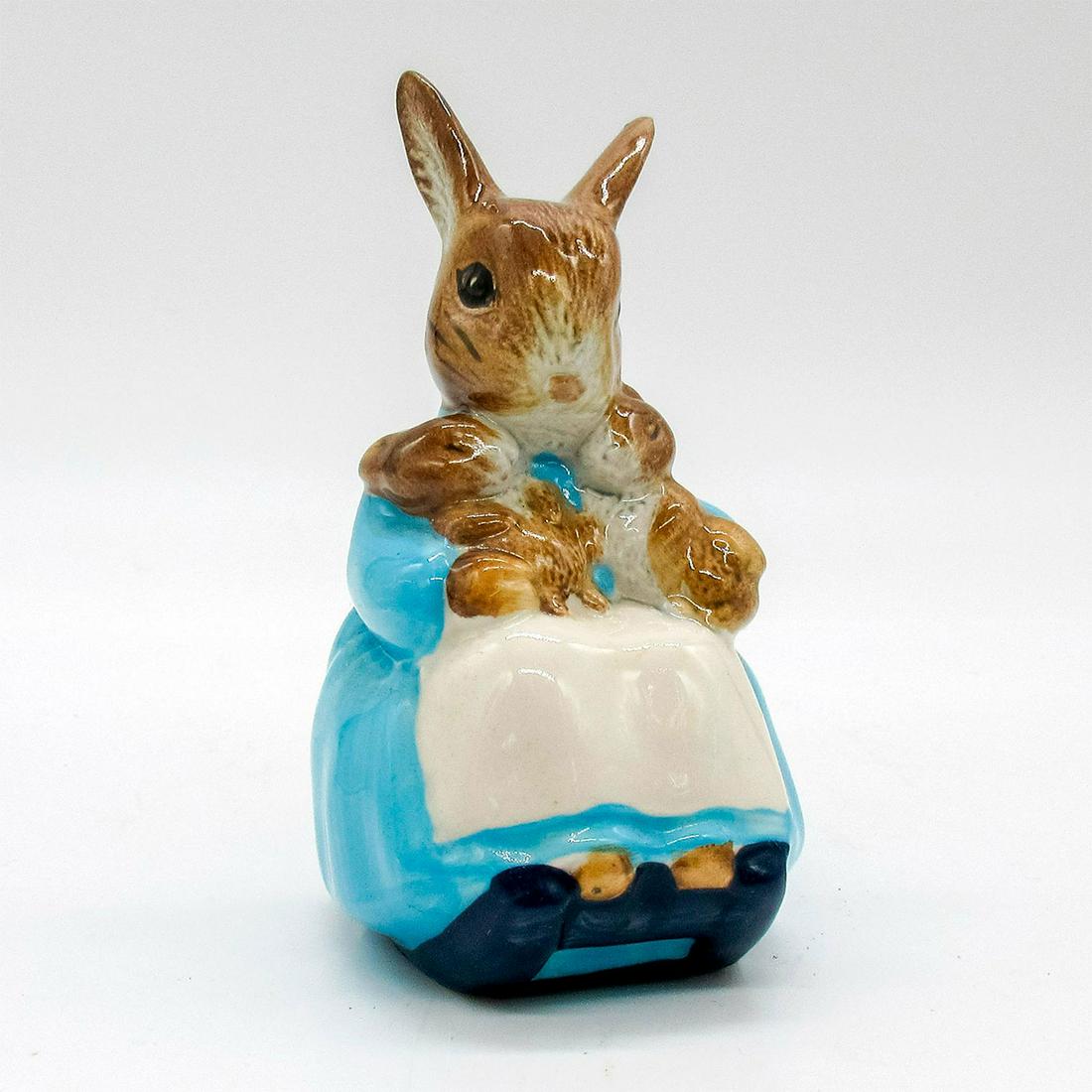 Mrs. Rabbit and Bunnies - Beatrix Potter Figurine: Brown bunny dressed in light blue dress with white apron rocking baby bunnies to sleep. Beswick backstamp. This item has no reserve. Issued: 1976 Dimensions: 3.5" H Manufacturer: Beswick Country of Or