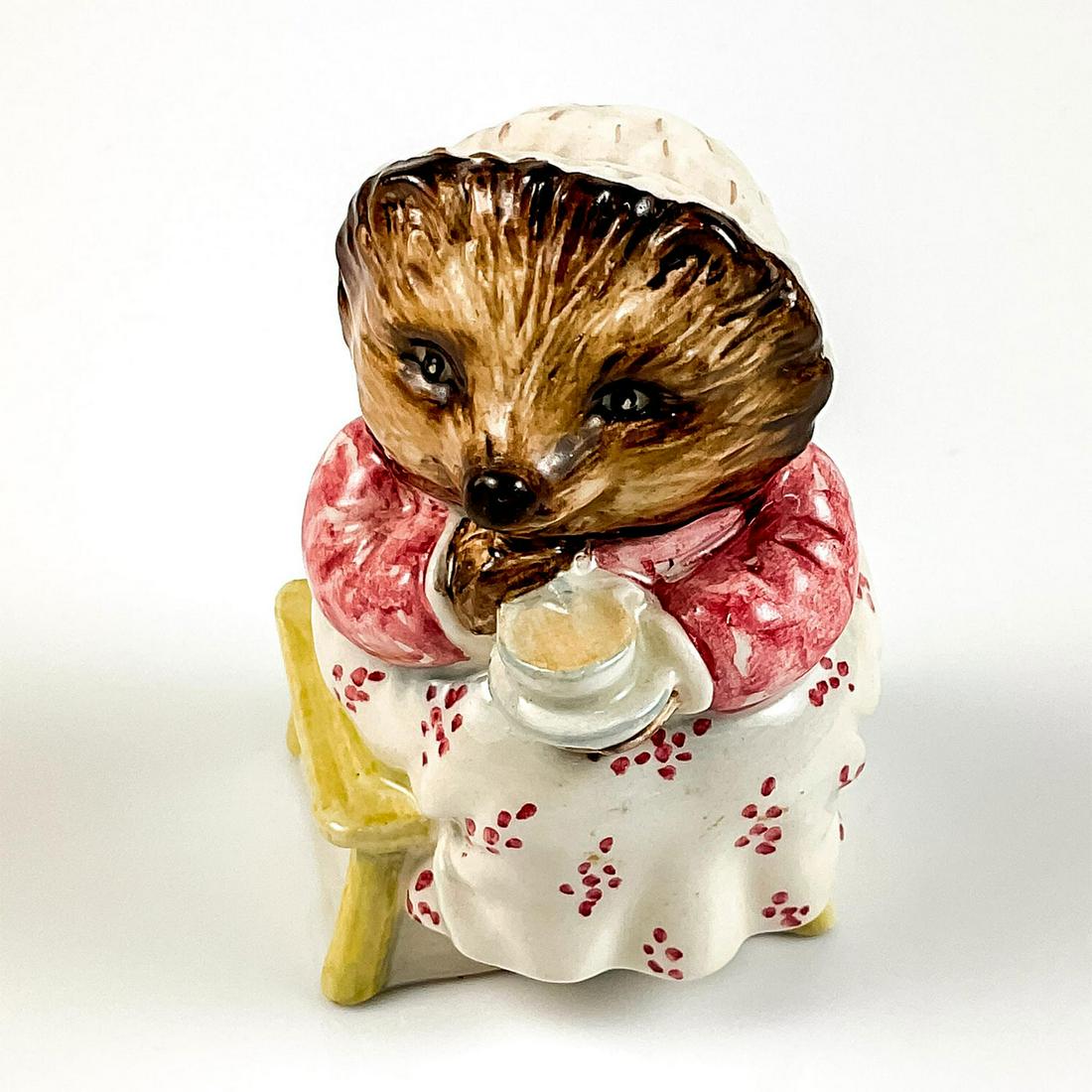 Mrs. Tiggy Winkle Takes Tea - Beatrix Potter Figurine: Vintage. Glossy finish. Depicts character wearing a pink and white dress, and white and brown mob cap. Beswick and Frederick Warne P.L.C. backstamps. This item has no reserve. Dimensions: 3.25" H Manu