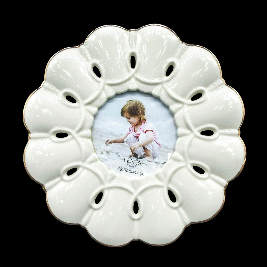 Lenox Porcelain Photograph Frame, Bloom: Round ivory white porcelain photograph frame. Edges detailed with 24k gold. Bloom shape with looped designs. Holds 3"x3" photograph. Lenox backstamp. Original box included. Box dimensions: 2"H, 9.25"W