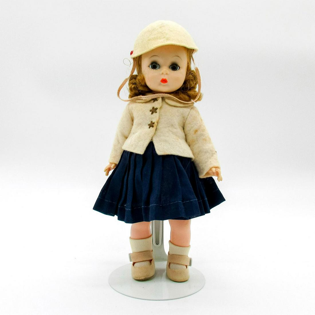 Vintage Madame Alexander Doll, Wendy Kin: Vintage doll with short curly hair. Blue pleated skirt with white felt coat with star shaped buttons. Felt cap included. Stand included. Madame Alexander tags. Issued: 20th c. Dimensions: 8" H Manufac