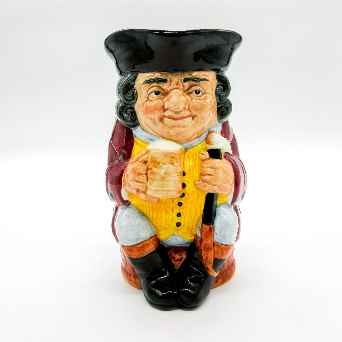Jolly Toby Blue - Royal Doulton Toby Jug: Black hat; burgundy coat; yellow waistcoat with either 6 or 7 buttons; blue- grey breeches. Series: English (UK) Heritage. Royal Doulton backstamp. Artist: Harry Fenton Dimensions: 6''H Manufacturer: 