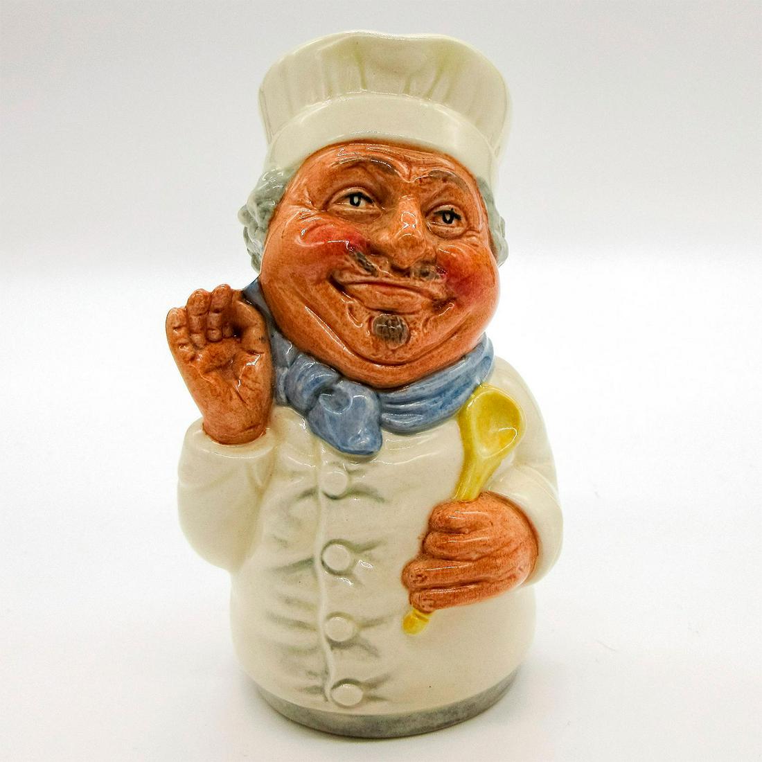 Monsieur Chasseur the Chef D6769 - Royal Doulton Toby Jug: White chef's coat and hat; blue scarf. Series: The Doultonville Collection. Royal Doulton backstamp. Artist: William K. Harper. Issued: 1987 - 1991 Dimensions: 4''H Manufacturer: Royal Doulton