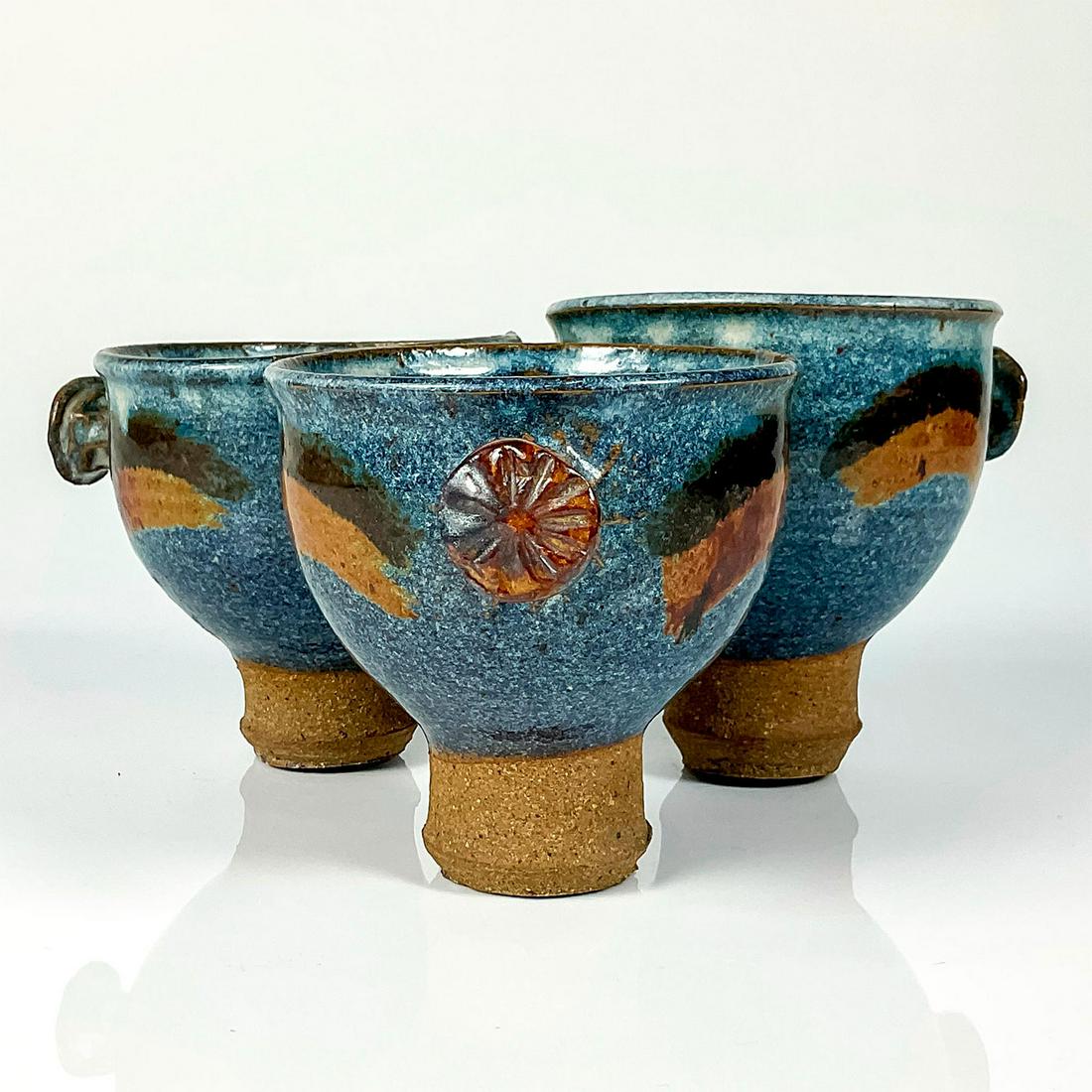 Vintage Studio Art Pottery, Triple Vase: Uniquely crafted trio of vases with knob handles and bases. Blue glaze with brown line design to bodies. Vases are adhered together. Dimensions: 9.5" W x 5" H