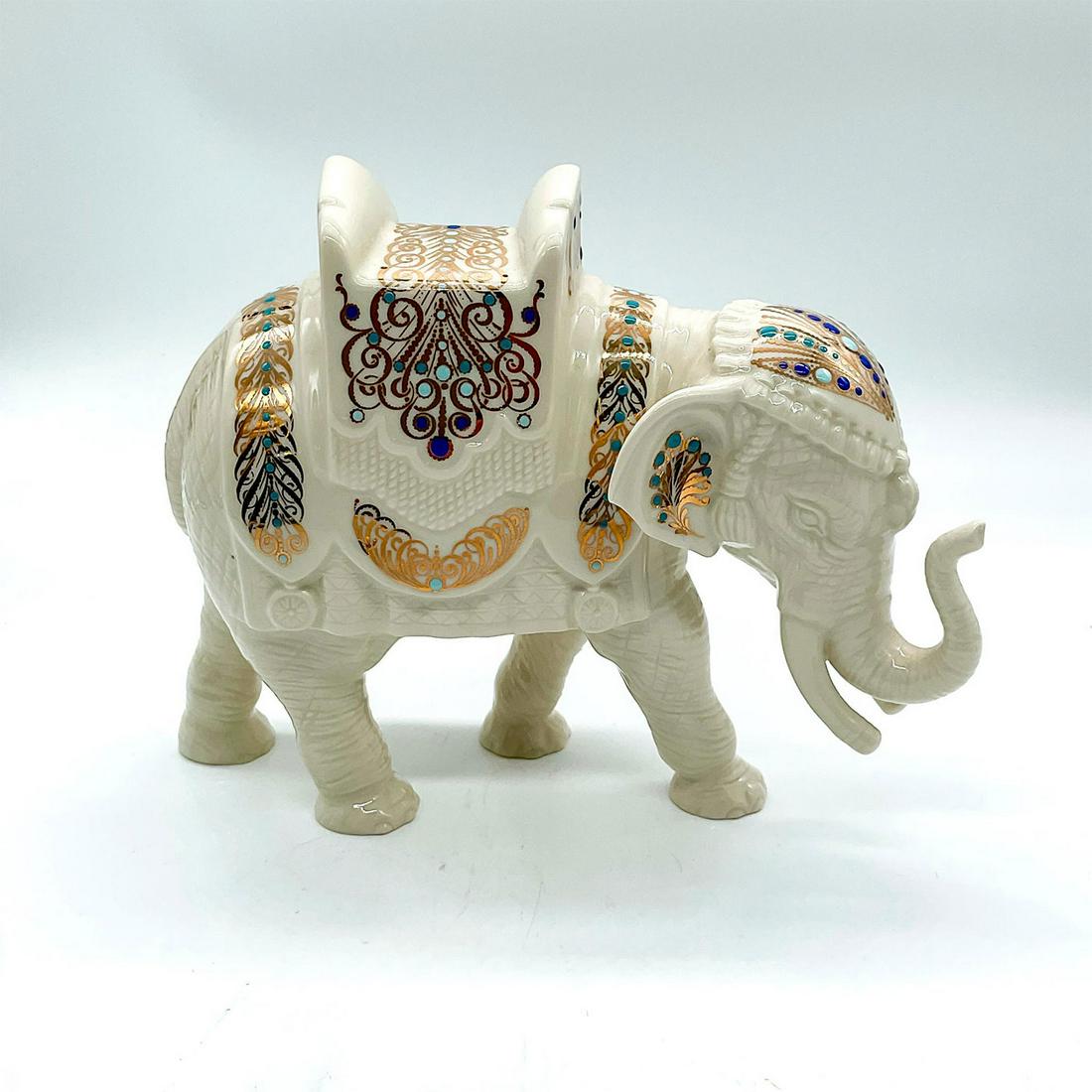 Lenox Bone China Figurine, China Jewel Nativity Elephant: Ivory-color figure of an Indian elephant adorn with navy and turquoise, and gilded accents. Lenox backstamp. This item has its original box: 11.75"L x 7.75"W x 7.75"H. This item has no reserve. Issued