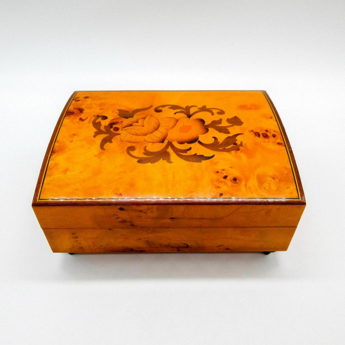 Italian Wooden Wind-Up Musical Jewelry Box: Plays 'The Way We Were'. Hinge covered box with flowers on top. 'Made in Italy' sticker on the base. 'S' embossed on the wind-up key. Dimensions: 5.75"L x 4.5"W x 2.75"H Country of Origin: Italy