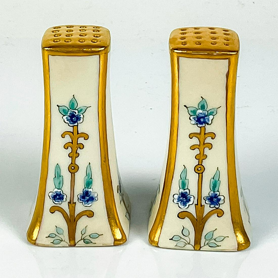 Antique P.L. Limoges Bone China Salt and Pepper Shakes: Gilded off white shakes; Art Nouveau style blue flowers. P.L. Limoges France backstamps. Dimensions: 1.5"L x 1.5"W x 3"H Manufacturer: P.L. Limoges Country of Origin: France
