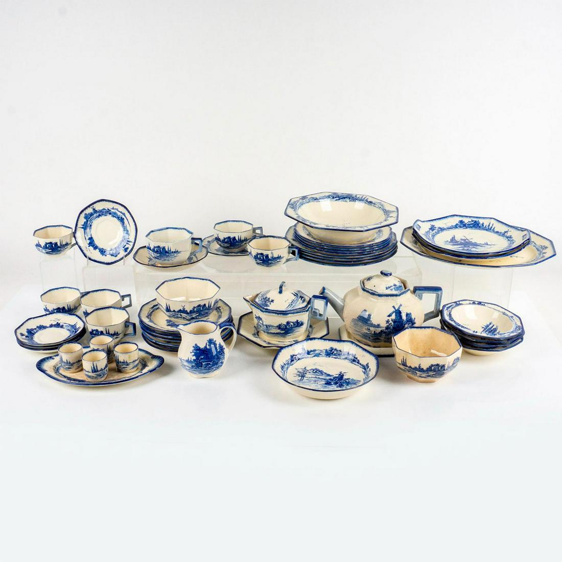 36pc Antique Royal Doulton Bone China Breakfast Set: Includes 4 cups, 4 saucers, 4 egg cups and tray, creamer and sugar with plate, teapot, 4 small bowls, 12 plates, 3 serving plates, 2 serving bowls, and a dessert bowl. Decorated in a rare blue windmil