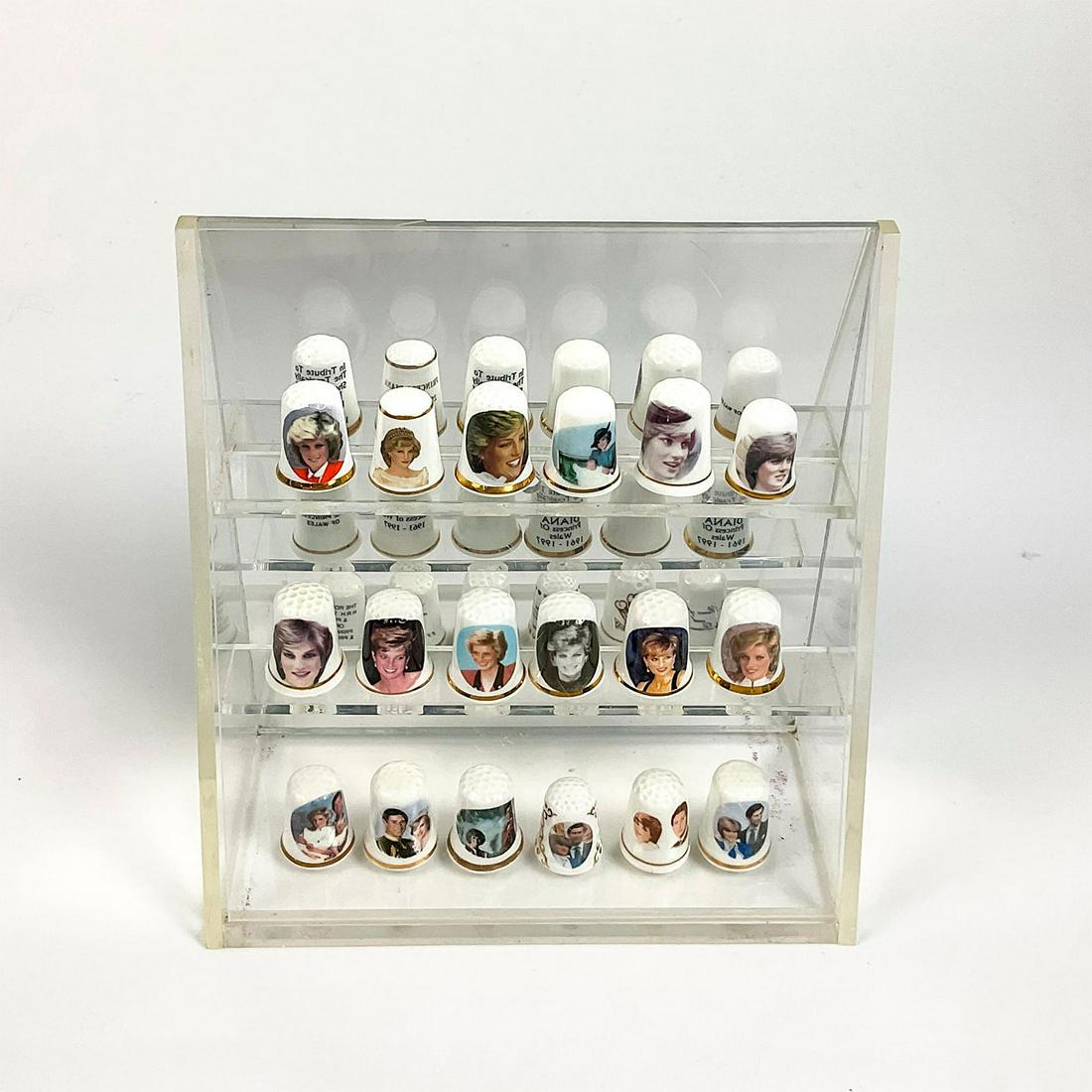 19pc Vintage Collectible Princess Diana Thimbles: Bone china thimbles honoring life of Princess Diana and her marriage to Prince Charles. Includes 18 thimbles and mirrored acrylic display case. 1"H each. Box dimensions: 7.25"W x 7.5"H. Issued: 20th c