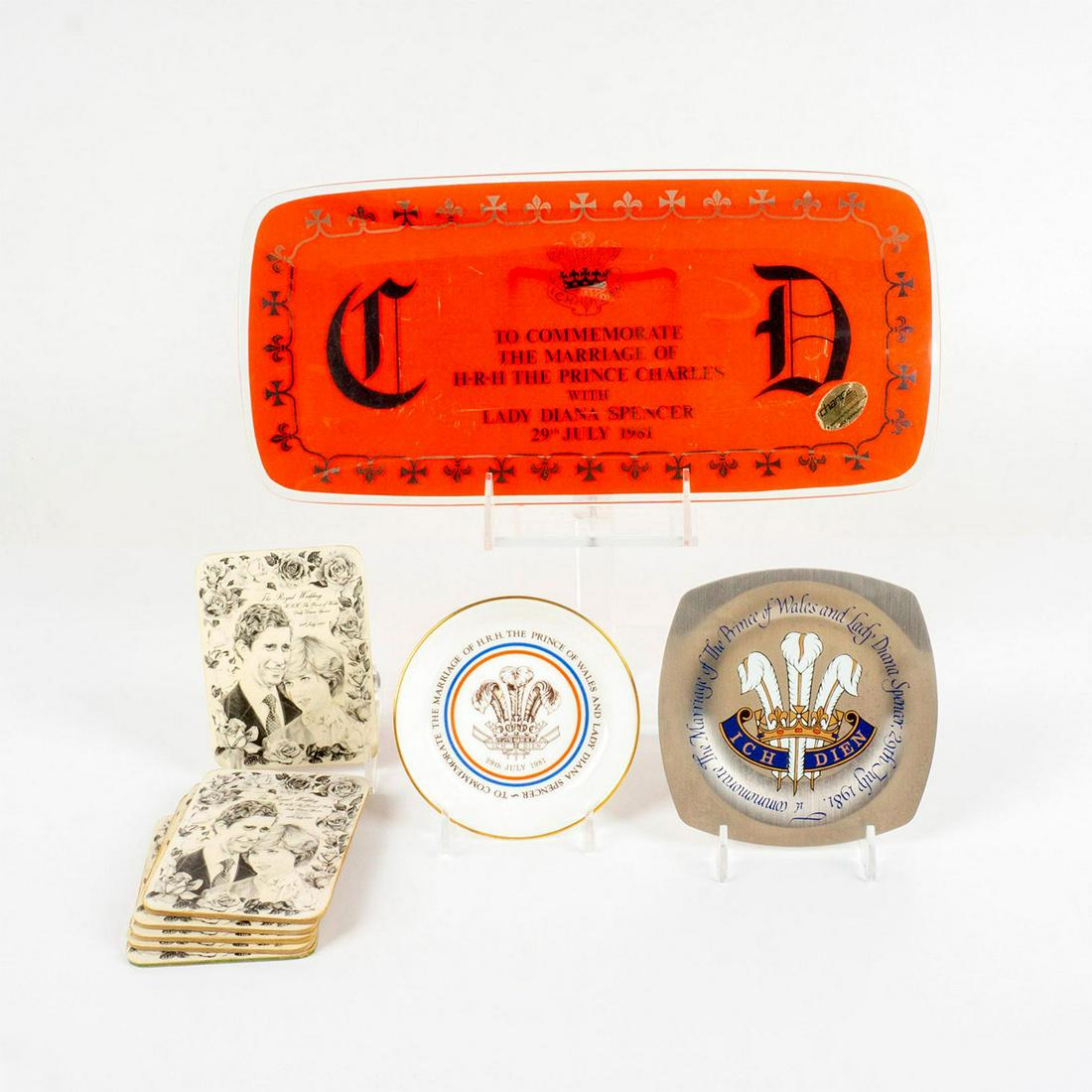 4pc Prince Charles and Lady Diana Celebrative Collectibles: Chance Glass tray, silver tone tray, Royal Worcester bone china dish, and 6 Mick Dolby pencil drawn coasters. Largest: 13.5"L x 6.25"W. Issued: 20th c. Dimensions: 8.75" dia. Country of Origin: Englan