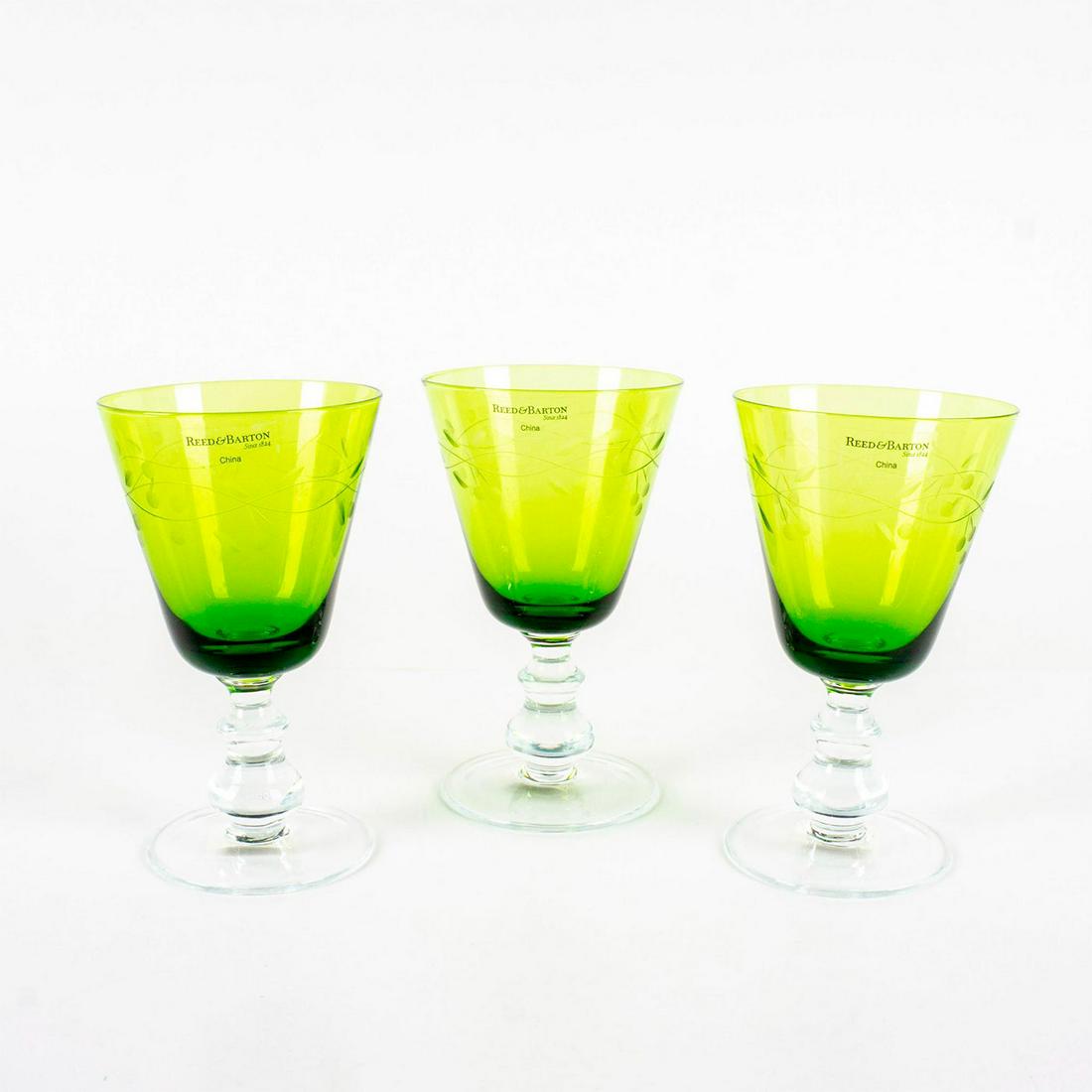 3pc Reed & Barton Williamsburg Green Goblet Glasses: Green glass bowl with etched fruit and leaves on vine design. Clear glass stem. In original box 7.25"H x 8.75"W x 8.75"L. One of the glasses has a minor chip on the rim. Issued: 20th c. Dimensions: 4"