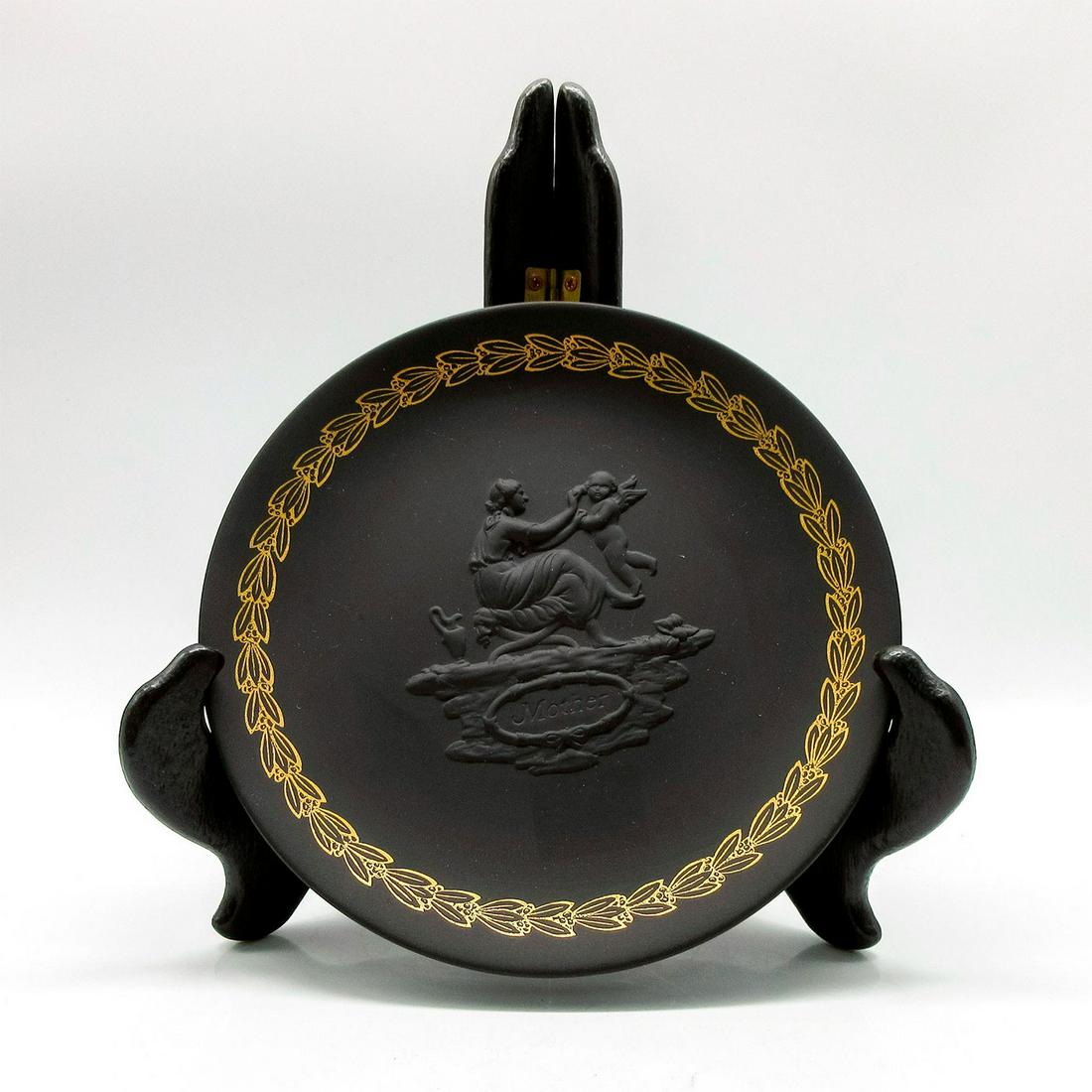 Wedgwood Black Basalt Jasperware Mother's Day Plate England: Depicting a lady playing with Cherub in the middle. Gilded rim. Wedgwood markings on the base. Comes with original box. #Mother #Cherub #Wedgwood Issued: 20th c. Dimensions: 6.5" dia. Manufacturer: We