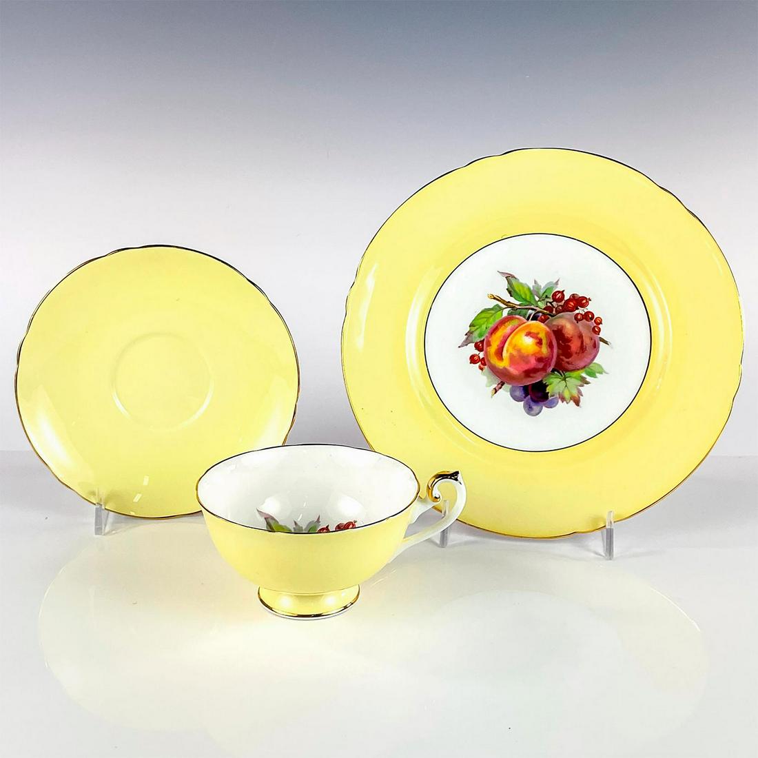 Vintage Shelley Tea Set Trio, Yellow Fruit Center: Includes teacup, saucer, and plate. Richmond shaped bone china with fruit in center and yellow color way with gold rim. This item has no reserve. Shelley England backstamp on base. Dish measures: 8.25