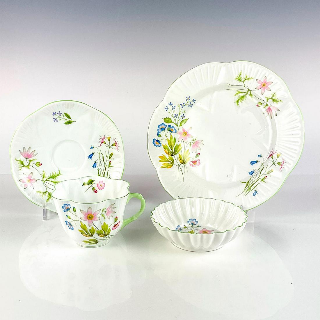 4pc Vintage Shelley Tea Set, Wild Anemone: Includes teacup, saucer, side plate and bon bon dish. Dainty shaped bone china with colorful floral pattern and green scalloped rim. This item has no reserve. Shelley England backstamp on base. Dish m