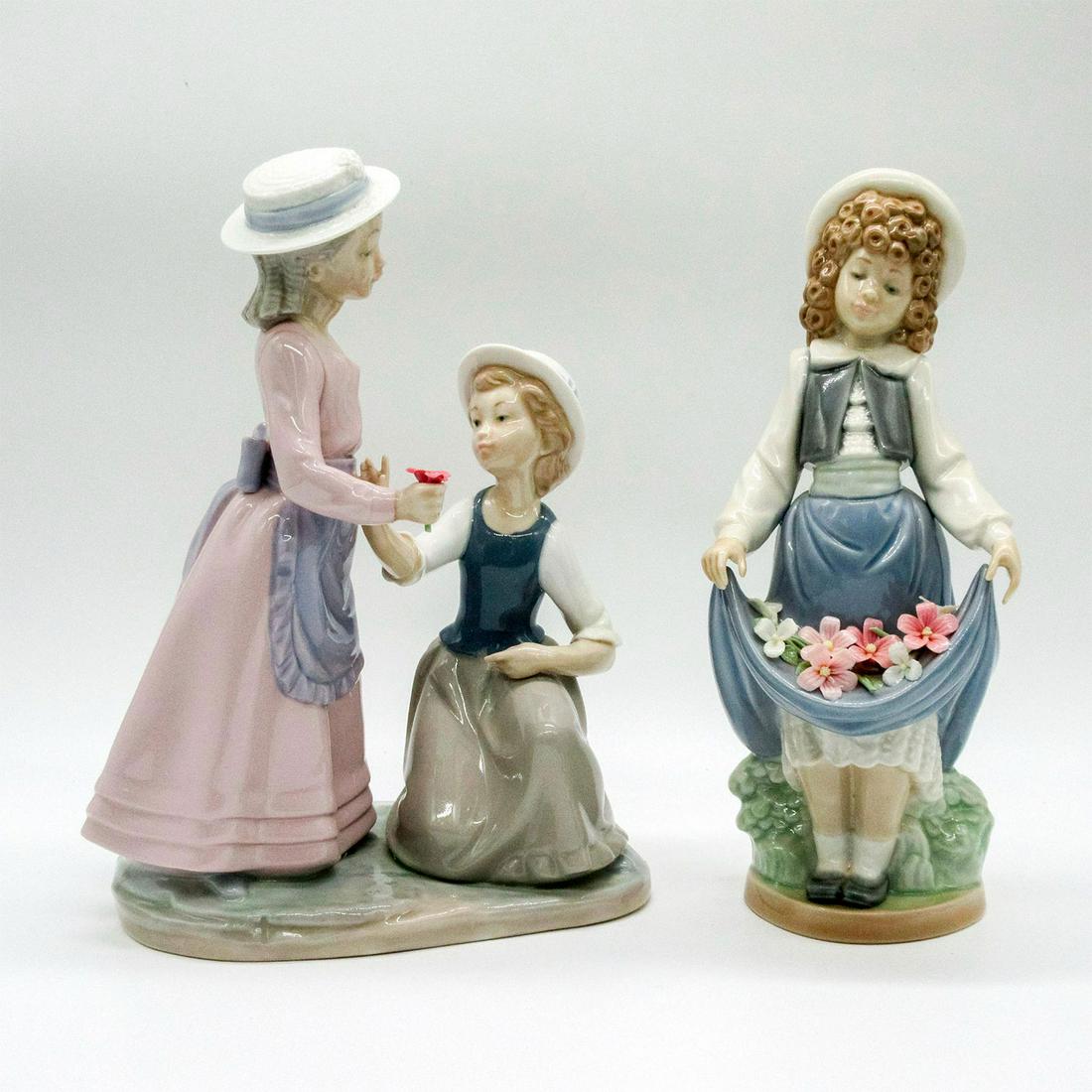 2pc Nao by Lladro Porcelain Flower Girl Figurines: Glossy finish. Nao backstamps. Includes the Schoolgirl, and two girls picking flowers. The Schoolgirl: Francisco Catala; 1986; 3.5in x 3.5in x 8.75in. Two Girls Picking Flowers: circa 1979; 4.5in x 6.
