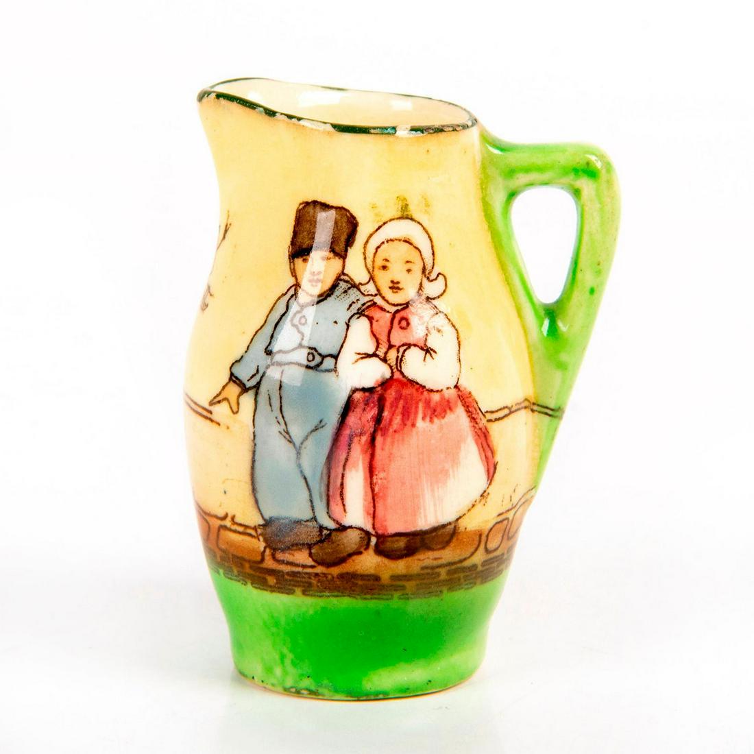 Royal Doulton Tiny Tableware Pitcher Children: Tiny pitcher; Green handle and foot. Hand painted scene of Dutch children. Doulton backstamp. Issued: 20th c. Dimensions: 2"H Manufacturer: Royal Doulton Country of Origin: England
